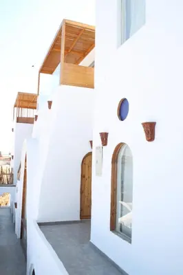 a white house with stairs and a window at nubiary in Jazīrat Salūjah
