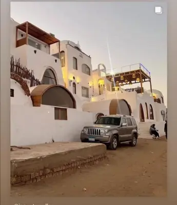 a silver jeep parked in front of a building at nubiary in Jazīrat Salūjah