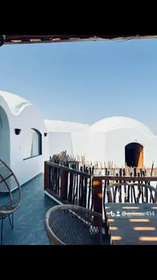 a view of a building with a table and chairs at nubiary in Jazīrat Salūjah
