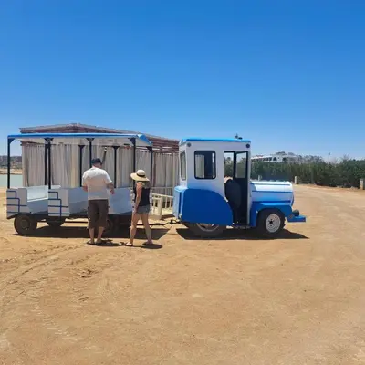 a man and a woman standing next to a blue truck at Princess Resort 109 B Al Mamsha Al Seyahi in Hurghada