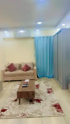 a living room with a couch and a coffee table at Princess Resort 109 B Al Mamsha Al Seyahi in Hurghada