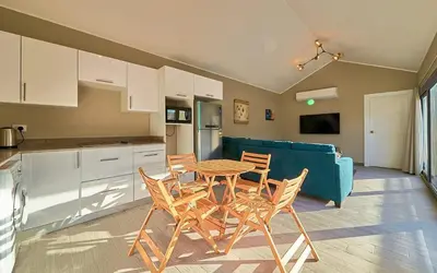 a kitchen with a table and chairs and a blue couch at Bali 2 BR private pool el gouna heated pool in Hurghada