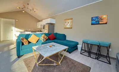 a living room with a blue couch and a table at Bali 2 BR private pool el gouna heated pool in Hurghada