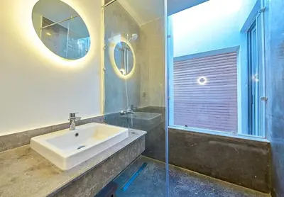 a bathroom with a sink and a glass shower at Bali 2 BR private pool el gouna heated pool in Hurghada