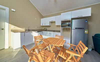 a kitchen with a table and chairs and a refrigerator at Bali 2 BR private pool el gouna heated pool in Hurghada