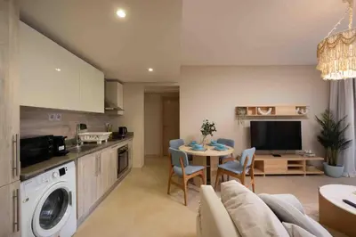a kitchen and living room with a couch and a table at Mangroovy Stays El Gouna - BirdNest in Hurghada