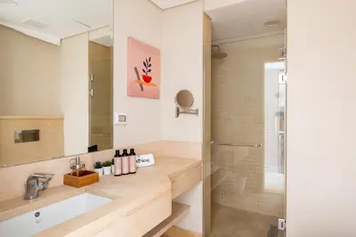 a bathroom with a sink and a shower at Mangroovy Stays El Gouna - BirdNest in Hurghada
