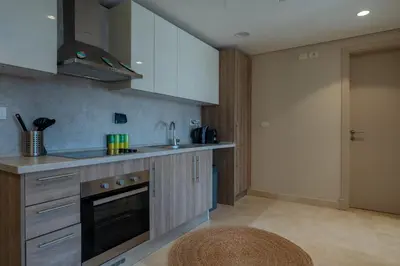 a kitchen with a sink and a stove at Mangroovy Stays El Gouna - BirdNest in Hurghada