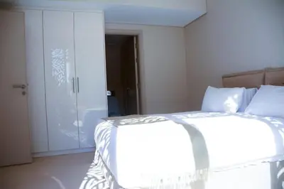 a white bedroom with a bed and a shower at mangrovey M9-2B--01 in Hurghada