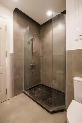 a bathroom with a glass shower with a toilet at Al Saraya Sahl Hasheesh by Peaks Studio with Pool View C106 in Hurghada