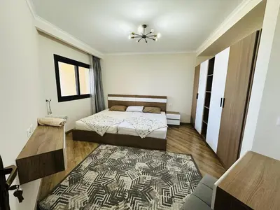 a bedroom with two beds and a rug at Beautiful Island View in Hurghada