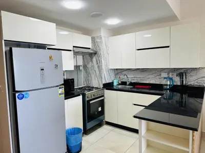 a kitchen with white cabinets and a white refrigerator at Beautiful Island View in Hurghada