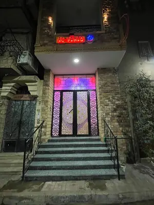 a staircase with a stained glass window and a sign at Al FAHAD private apartments for rent in Luxor