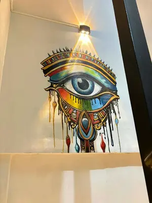 a painting of an eye on a wall at Al FAHAD private apartments for rent in Luxor