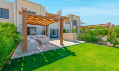 a backyard with a pergola and a lawn at Luxury Stays in Shedwan El Gouna in Hurghada