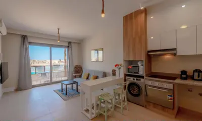 a kitchen and living room with a view of the ocean at Luxury Stays in Shedwan El Gouna in Hurghada