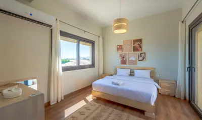 a bedroom with a bed and a large window at Luxury Stays in Shedwan El Gouna in Hurghada