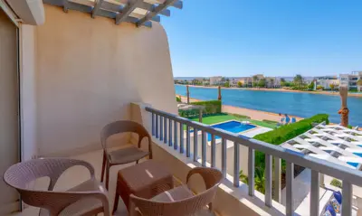 a balcony with chairs and a view of the water at Luxury Villas in Joubal El Gouna in Hurghada