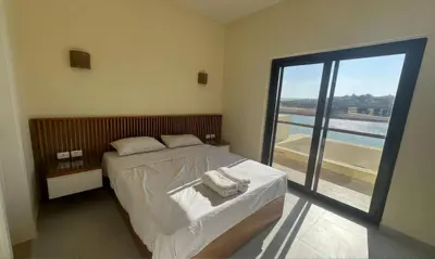 a bedroom with a bed and a large window at Luxury Villas in Joubal El Gouna in Hurghada