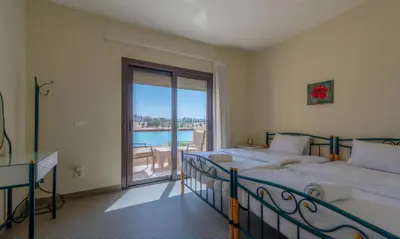 a bedroom with two beds and a large window at Luxury Villas in Joubal El Gouna in Hurghada
