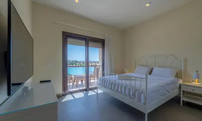 a bedroom with a bed and a balcony with a view at Luxury Villas in Joubal El Gouna in Hurghada