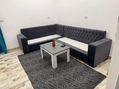 a black couch with a table in a room at White House in Hurghada