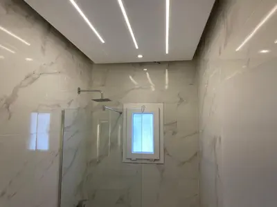 a bathroom with a shower and a window at White House in Hurghada