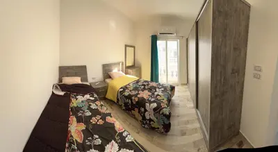 a bedroom with two beds in a room at White House in Hurghada