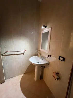 a bathroom with a white sink and a mirror at ATO luxurious apartments in Hurghada