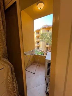 a room with a balcony with a view of a building at ATO luxurious apartments in Hurghada