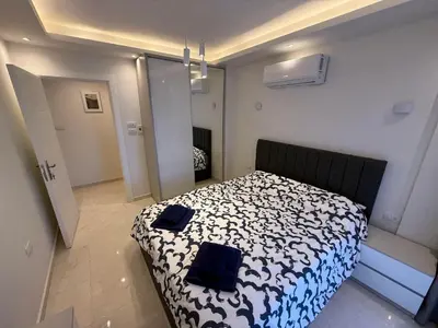 a bedroom with a bed with a black and white comforter at Luxury Selena Bay Apartment- Private Beach, Kite School 5 Pools in Hurghada