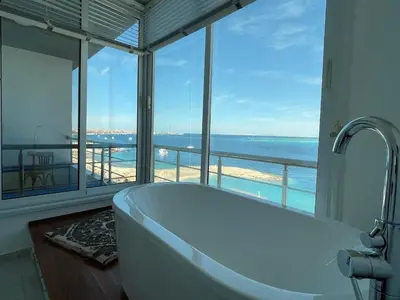 a bath tub in a bathroom with a view of the ocean at Amazing 2 bedroom apartment with sea view in Hurghada in Hurghada