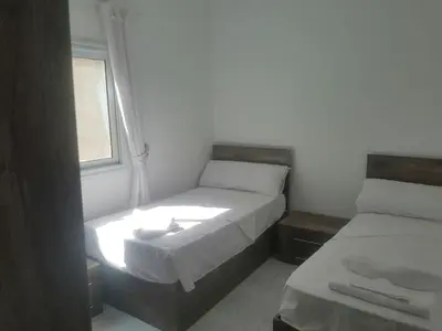 a small room with two beds and a window at Amazing 2 bedroom apartment with sea view in Hurghada in Hurghada