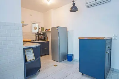 a kitchen with blue cabinets and a blue refrigerator at Amazing 2 bedroom apartment with sea view in Hurghada in Hurghada