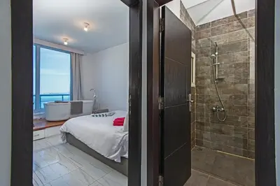 a bedroom with a shower and a bed and a tub at Amazing 2 bedroom apartment with sea view in Hurghada in Hurghada