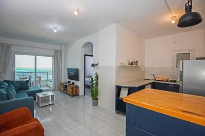 a kitchen and living room with a couch and a table at Amazing 2 bedroom apartment with sea view in Hurghada in Hurghada