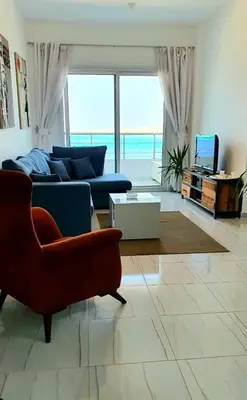 a living room with a couch and a table at Amazing 2 bedroom apartment with sea view in Hurghada in Hurghada