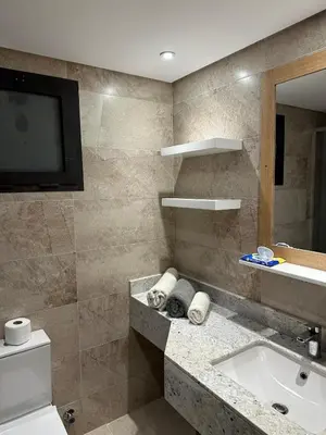 a bathroom with a sink and a toilet and a television at Luxury Apartment In The View in Hurghada