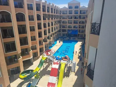 an empty pool in a building with a water slide at Stylish studio with sea view in Hurghada