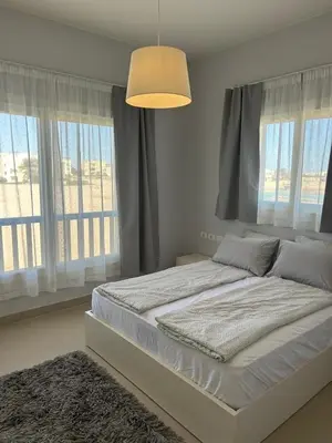 a bedroom with a large white bed with windows at El Gouna 1 Bedroom Waterside in Hurghada