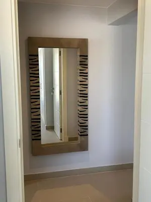 a mirror on a wall in a bathroom at El Gouna 1 Bedroom Waterside in Hurghada