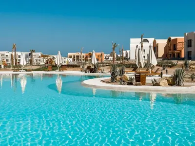 a large pool with blue water in a resort at Kamaran 2BR • Luxurious Retreat in Hurghada