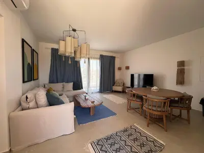 a living room with a couch and a table at Kamaran 2BR • Luxurious Retreat in Hurghada
