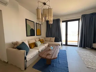 a living room with a couch and a coffee table at Kamaran 2BR • Luxurious Retreat in Hurghada