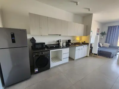 a kitchen with a refrigerator and a stove top oven at Duplex 1BR King Bed and1 Sofa Bed By the Pool in Hurghada