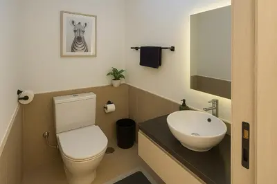 a bathroom with a toilet and a sink at Duplex 1BR King Bed and1 Sofa Bed By the Pool in Hurghada