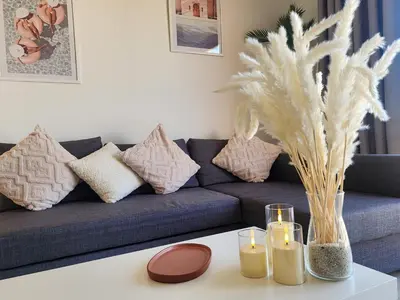 a living room with a couch and candles on a table at Duplex 1BR King Bed and1 Sofa Bed By the Pool in Hurghada