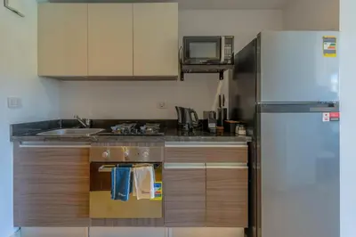 a kitchen with a refrigerator and a sink at The Contemporary Condo in Gouna in Hurghada