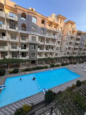 a large apartment building with a large swimming pool at Luxury One Bed Room Apartment in Hurghada