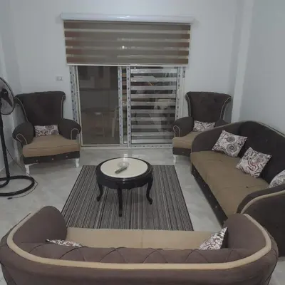 a living room with two couches and a coffee table at الغردقة الانتر in Hurghada